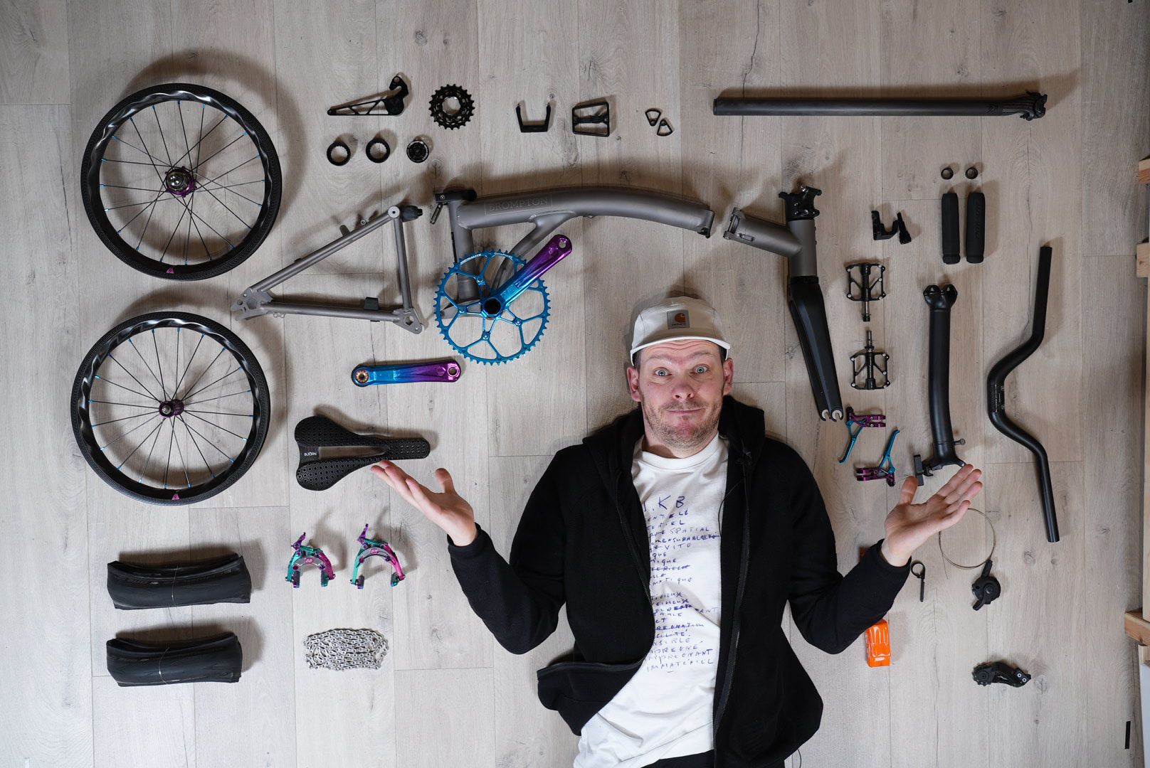 Oleg with disassembled custom Brompton build — flat lay